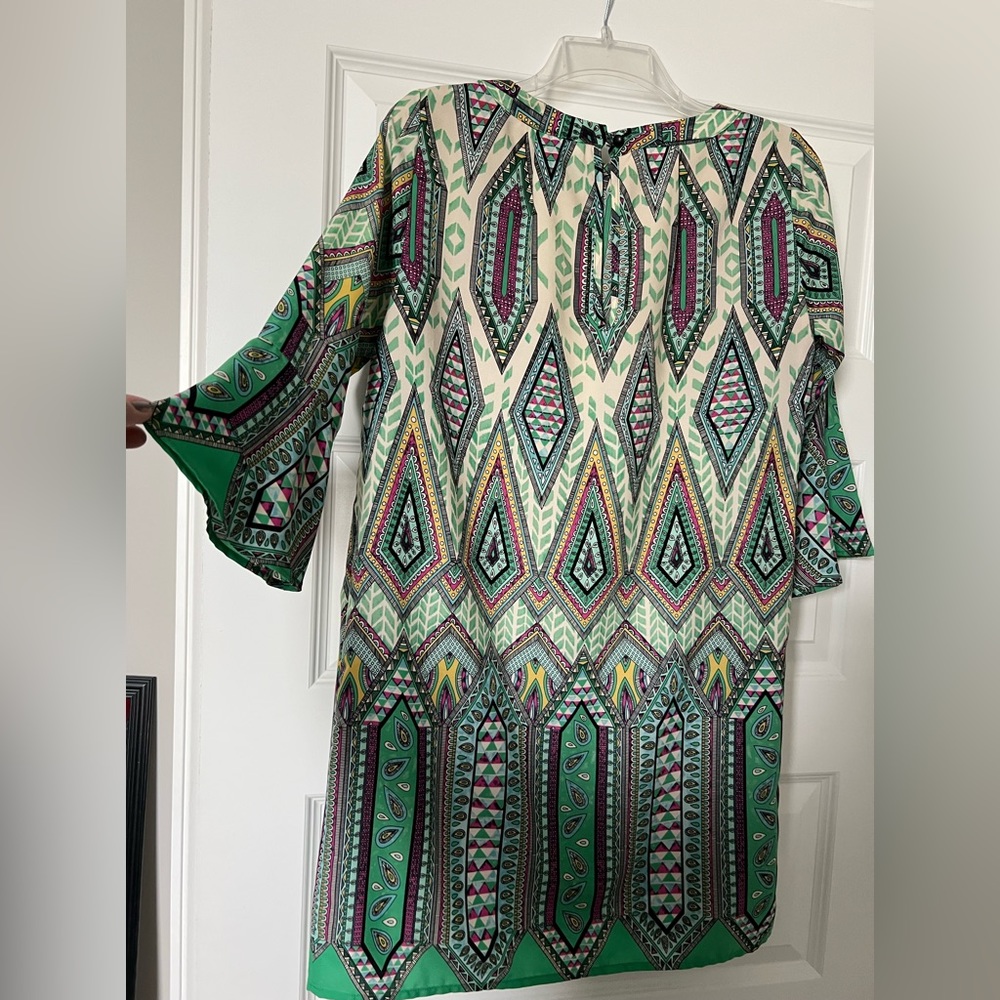 Green dress with 3/4 bell sleeves.